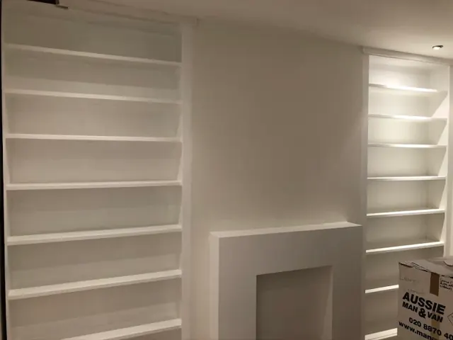 White painted shelving fitted into alcoves