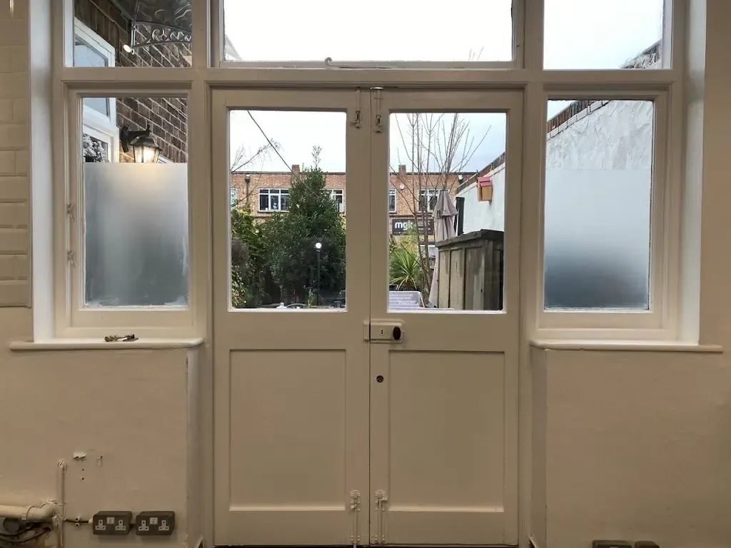 Freshly painted glazed double doors opening onto a garden