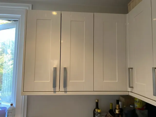 Kitchen wall cabinets with doors realigned after a hinge repair